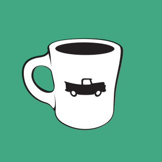 Coffee cup with truck illustration on it, the logo of Old Truck Good Coffee.