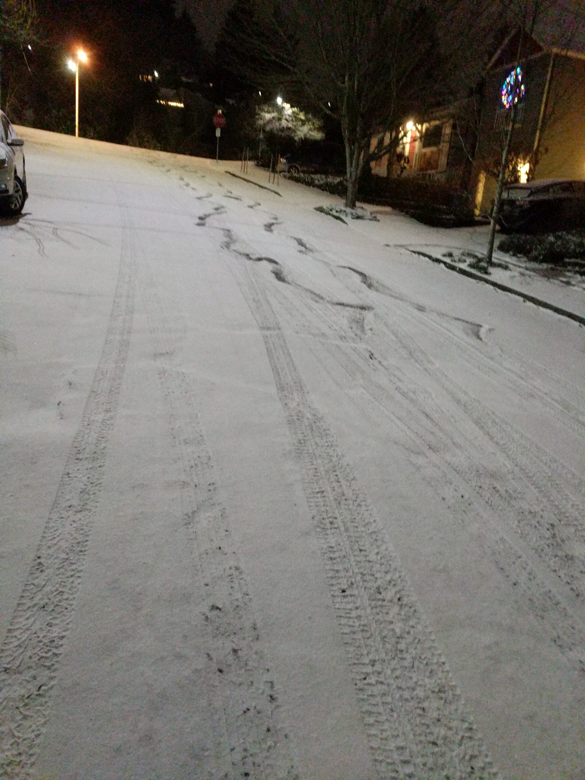 Car tracks in the light snow.